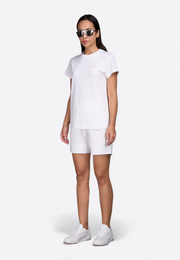 Model wearing high waist off-white shorts, front view – East Vibe